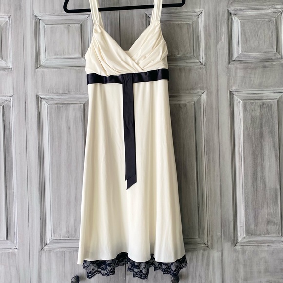 Dresses & Skirts - Ivory and black Cocktail dress with lace trim along bottom.